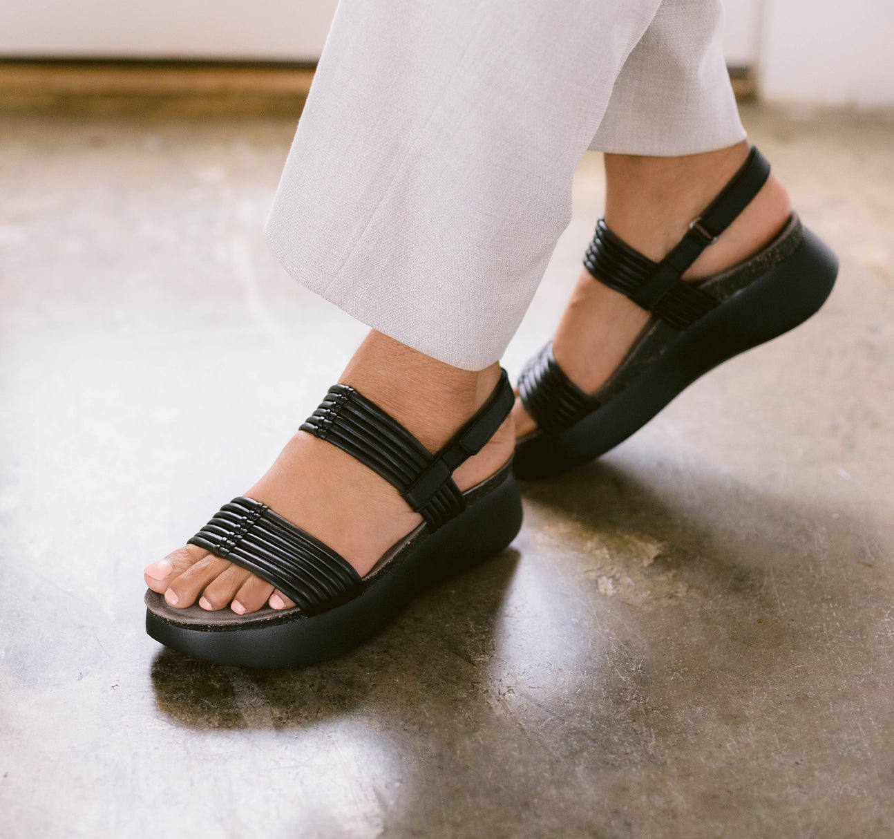 Alessia platform-wedge footbed sandal with rolled black lamb leather strip straps - lifestyle