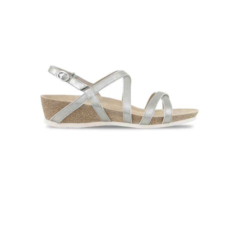 Tarifa silver metallic leather strappy sandal on low wedge platform with crisscross vamp and instep straps along with a hook & loop back strap-side view