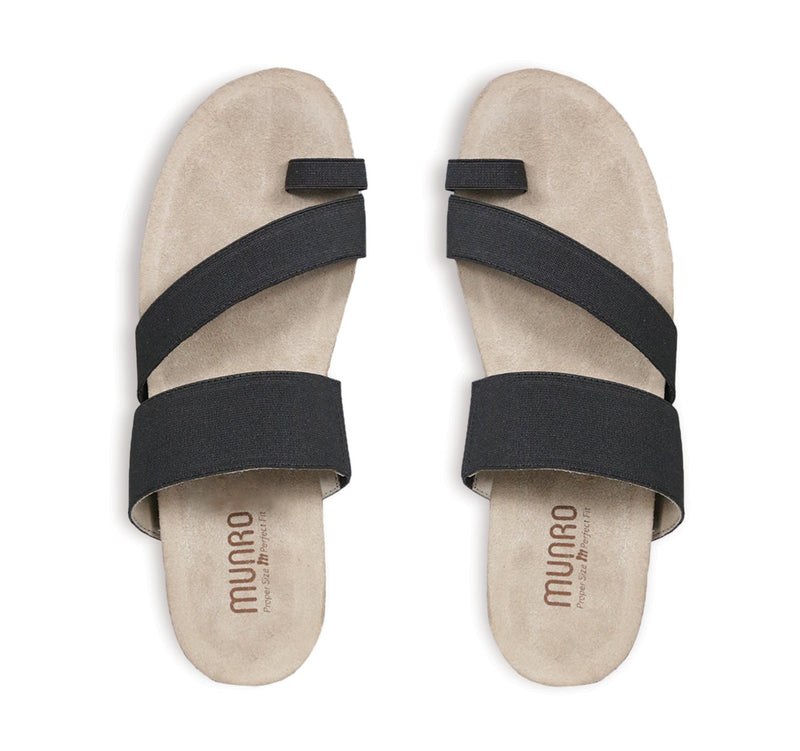 Aries toe-ring footbed slide sandal with asymmetrical vamp strap and wide band instep strap in black stretch fabric-top view