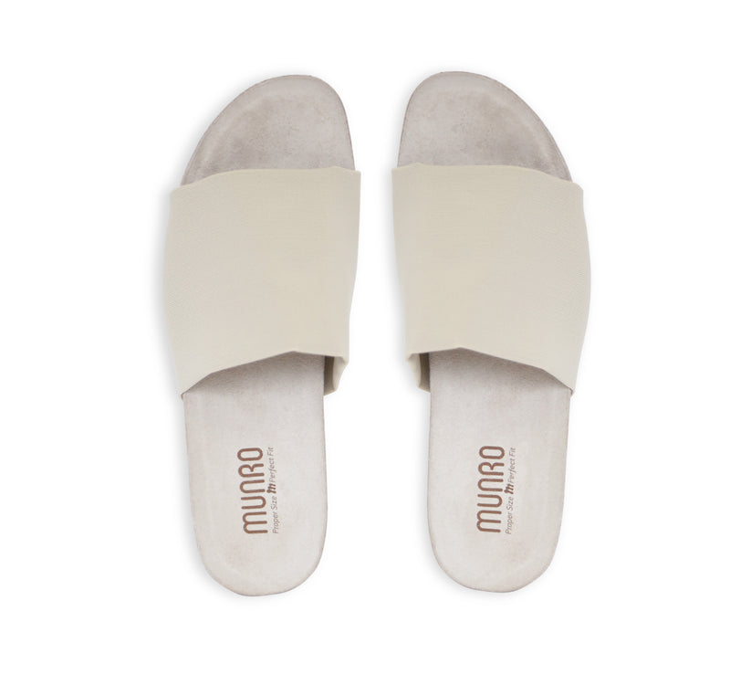 Casita single strap footbed slide sandal on low-wedge outsole in bone stretch fabric-top view